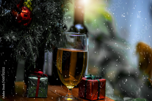 Wine bottle and glasses.with Christmas tree and gift box.