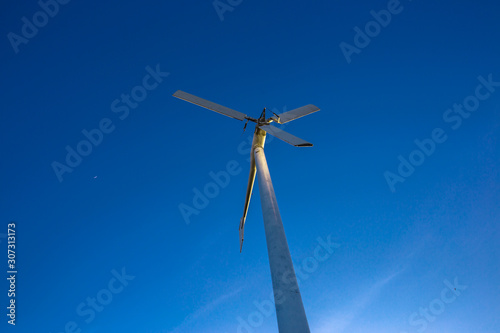 The background of large wind turbines, with fast blurred motion from the wind blowing to store energy, used to generate electricity for industrial use, energy-saving technology systems © bangprik