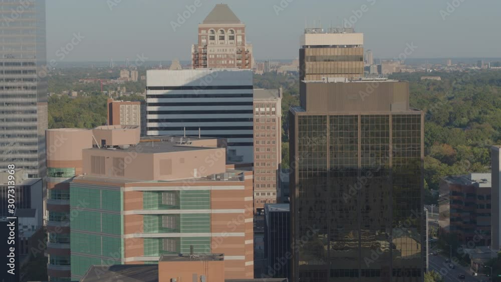 Midlevel view of office high-rises track right to reveal downtown St. Louis skyline on horizon
