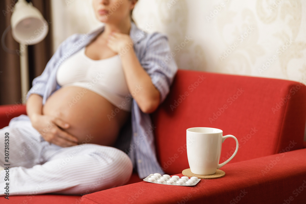 Young pregnant woman with a sore throat Young pregnant woman with a sore throat