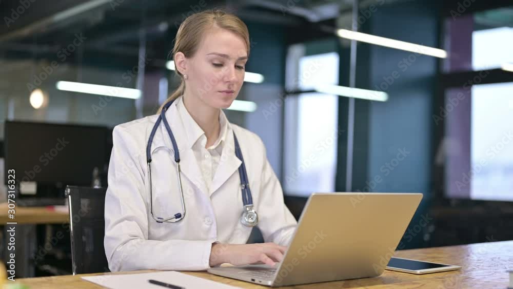 Ambitious Young Female Doctor doing Thumbs Up in Office Ambitious Young Female Doctor doing Thumbs Up in Office