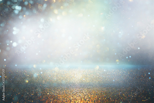 abstract background of glitter vintage lights . silver, gold and blue. de-focused