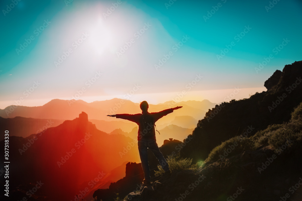 happy tourist enjoy hiking in sunset mountains