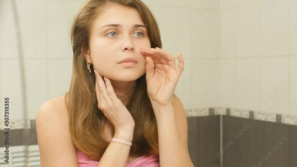 young woman in the bathroom preens and doing makeup, girl in morning routine, concept cosmetics and female beauty young woman in the bathroom preens and doing makeup, girl in morning routine, concept cosmetics and female beauty