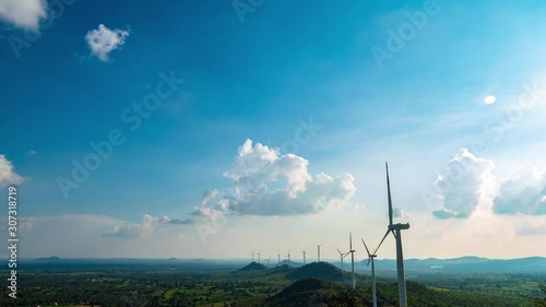 Time lapse of windmills spinning swiftly, in a wind farm in India