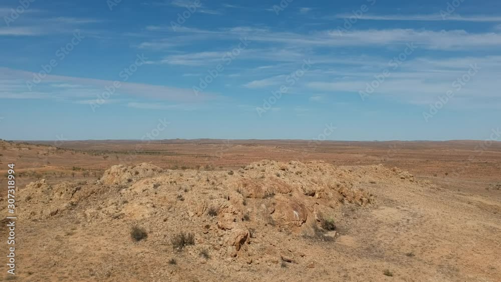 A huge rocky outcrop in the desolate outback of Australia A huge rocky outcrop in the desolate outback of Australia