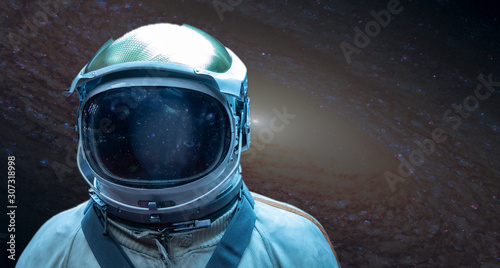 Fototapeta Naklejka Na Ścianę i Meble -  Astronaut in a front of stars in outer space. Conquest of Space Concept, Elements of this image were furnished by NASA