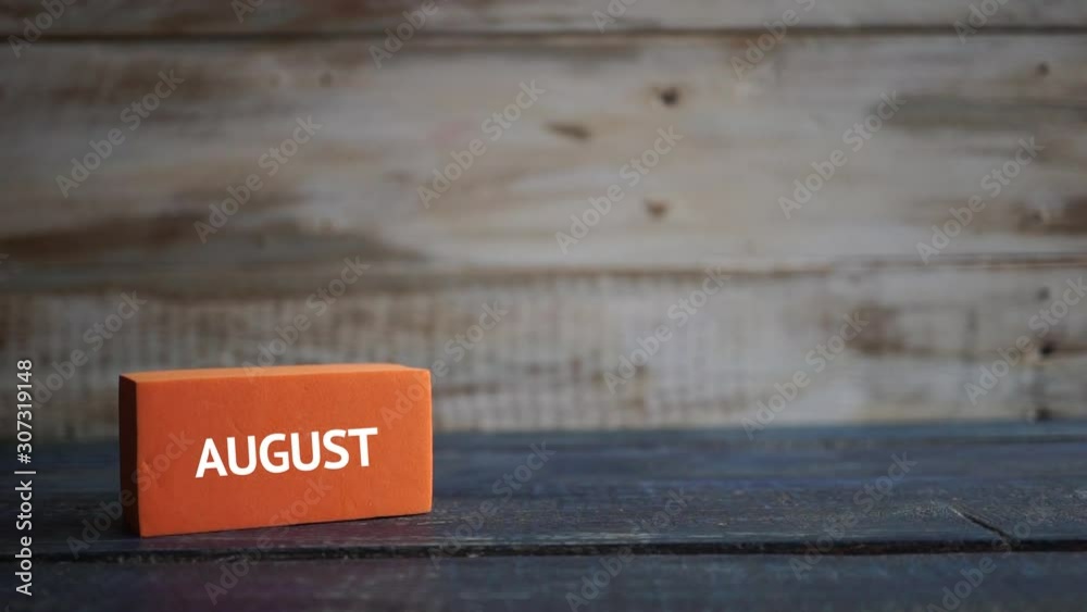 august 21st. Day 20 of month, calendar on a color cubes. hand puts the day of the month on the name of the month on a wooden background summer, day of the year concept august 21st. Day 20 of month, calendar on a color cubes. hand puts the day of the month on the name of the month on a wooden background summer, day of the year concept