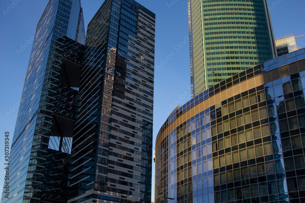 Obraz premium Modern skyscrapers in business district in evening light at sunset
