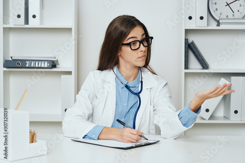 female doctor working on laptop in office