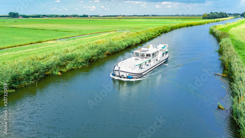 Foto Aerial drone view of houseboat in canal and country landscape of Holland from ab