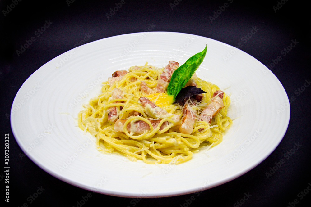 Carbonara paste on black background Carbonara paste on black background