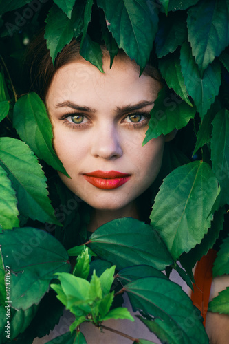 beautiful woman on green leaves park nature