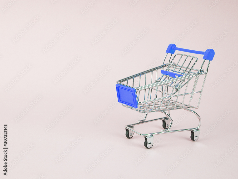 Small shopping cart on blue background. Space for text Small shopping cart on blue background. Space for text