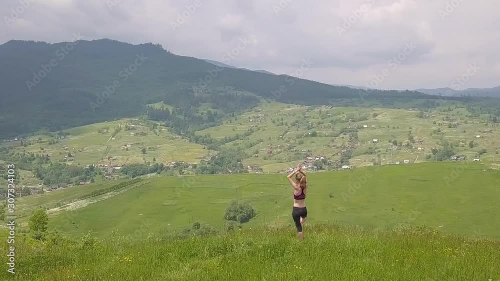 Young woman enjoying mountain view on a summer day. Relax and meditation in nature environment. Young woman enjoying mountain view on a summer day. Relax and meditation in nature environment.