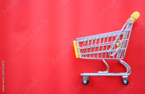 close-up of shopping trolley on Red background with some copy space © NOTE OMG