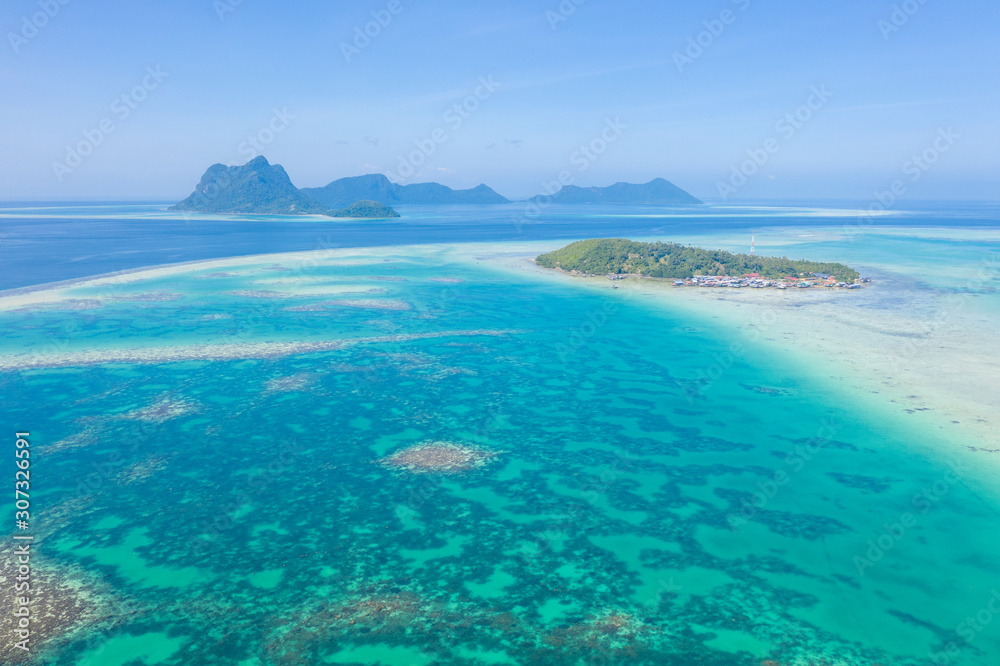 Aerial view of Sea Gypsy water village, island and the ocean with sky in Semporna, Sabah, Malaysia, Borneo. Aerial view of Sea Gypsy water village, island and the ocean with sky in Semporna, Sabah, Malaysia, Borneo.