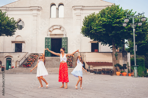 Adorable little girls and young mother have fun in italian old village © travnikovstudio