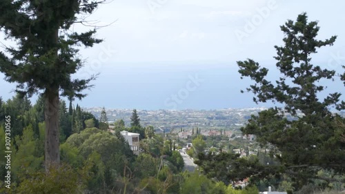 Landscape with trees, blue sky and sea.