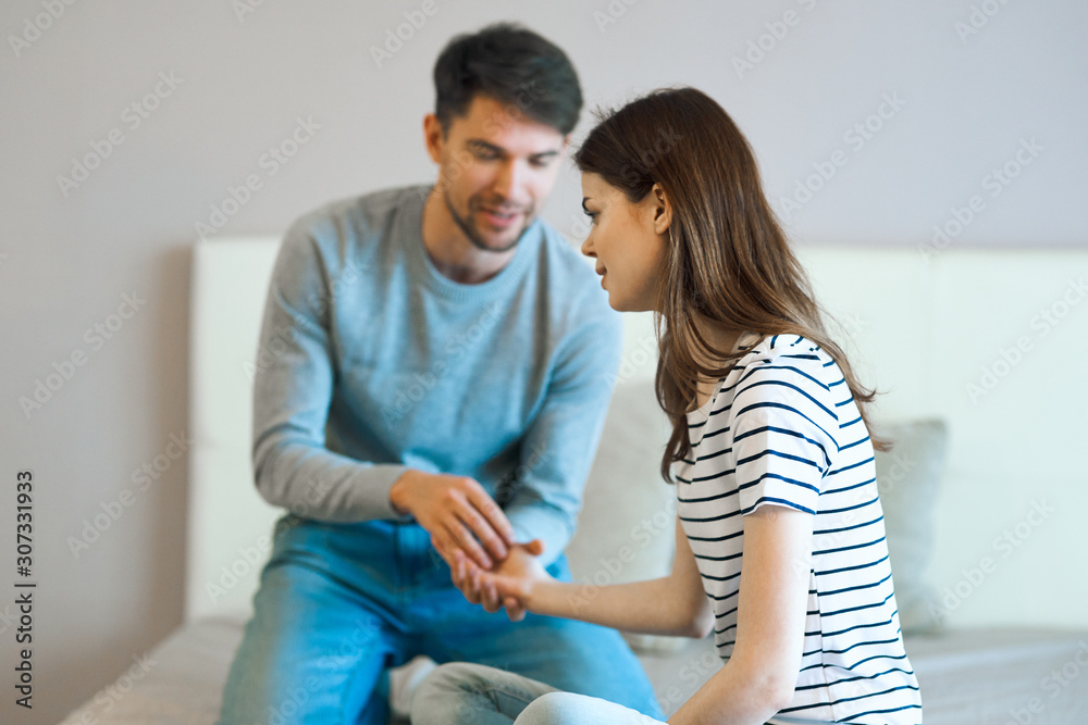 young couple sitting on sofa and watching tv young couple sitting on sofa and watching tv