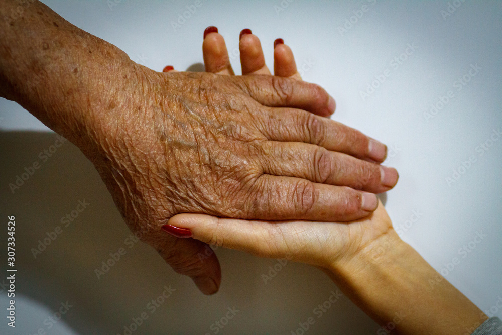 Fototapeta premium Old and Young Women Holding Hands