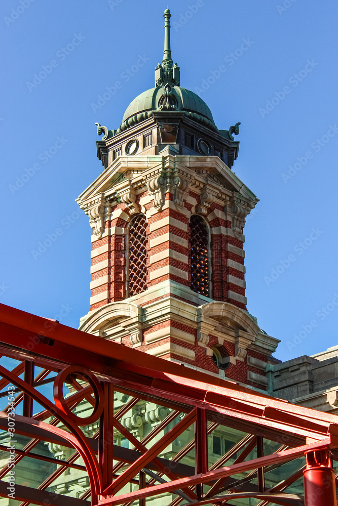 Ellis Island Immigrant Building bell tower close up. The museum is located in the Main Building of the former immigration station complex. New York, USA. Ellis Island Immigrant Building bell tower close up. The museum is located in the Main Building of the former immigration station complex. New York, USA.