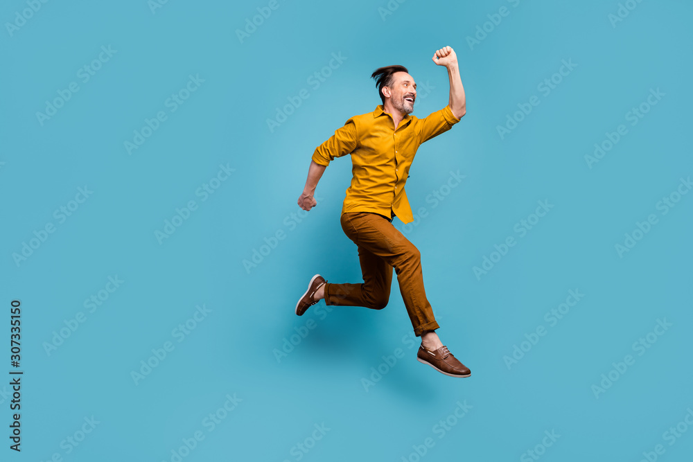 Full size profile side photo of cheerful crazy man cant wait black friday bargains jump hurry run fast wear good looking outfit sneakers isolated over blue color background