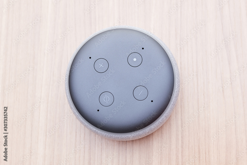 third generation amazon echo dot, white, top view four buttons, on a light  wooden table Stock Photo | Adobe Stock