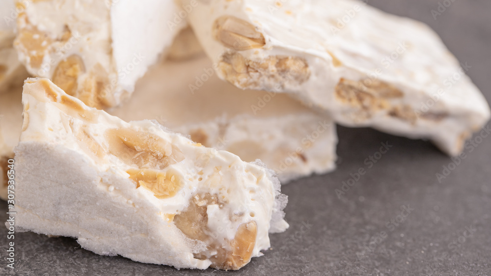 Close up of cracked Turron or hard nougat , typical Spanish sweet consumed at Christmas time.