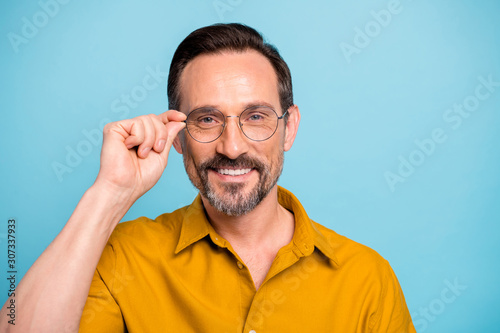Close up photo of cheerful man touch his stylish specs want look good feel content wear modern clothing isolated over blue color background