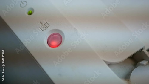 A light on a printer indicating that the printer encountering a problem with paper feeding