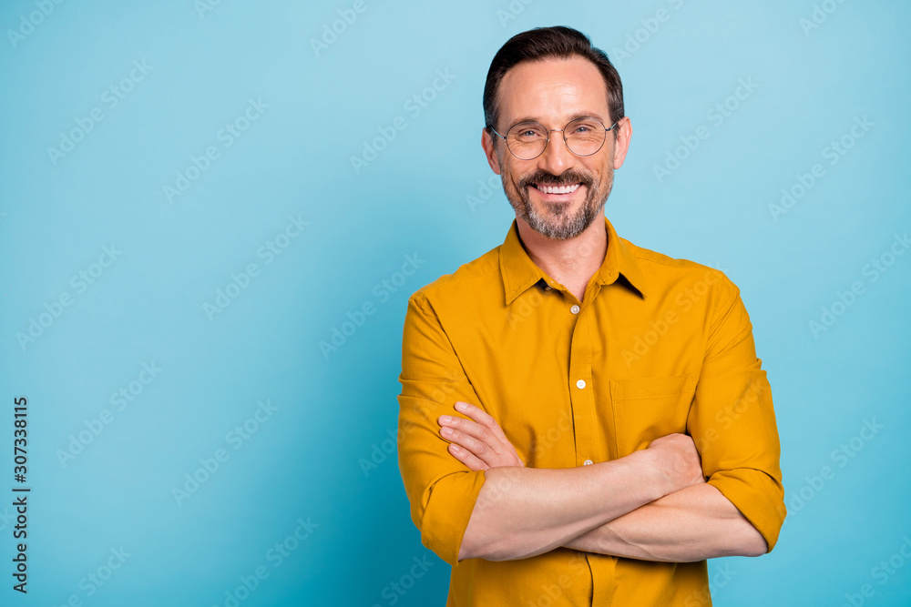 Portrait of charming mature man true boss feel content emotions wear yellow shirt isolated over blue color background - obrazy, fototapety, plakaty 