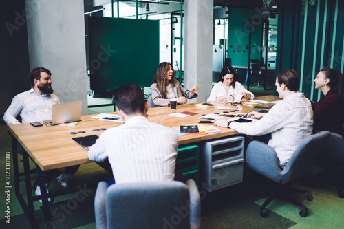 Businessmen and businesswomen sitting in meeting room