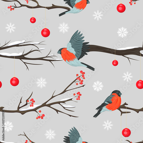 Seamless pattern with bullfinches, snowy rowan branches and decorative balls