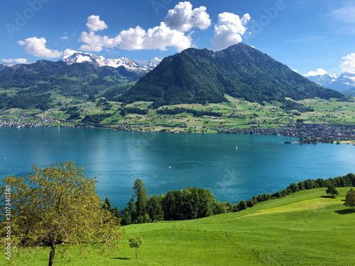 Settlement Buochs on the shores of Lake Luzerne or Vierwaldstaettersee (Vierwaldsattersee), at the end of the Engelbergertal Valley and Mountain Buochserhorn - Canton of Nidwalden, Switzerland photo