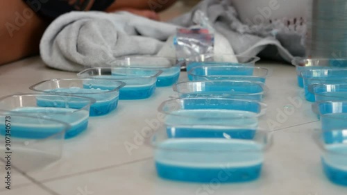 Homemade soap making process - after pouring hot liquid soap into molds, spraying a little bit of Isopropyl Alcohol 91% to break up the air bubbles to make the finished soap more smooth and beautiful