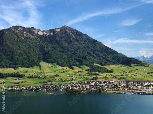 Settlement Buochs on the shores of Lake Luzerne or Vierwaldstaettersee (Vierwaldsattersee), at the end of the Engelbergertal Valley and Mountain Buochserhorn - Canton of Nidwalden, Switzerland photo