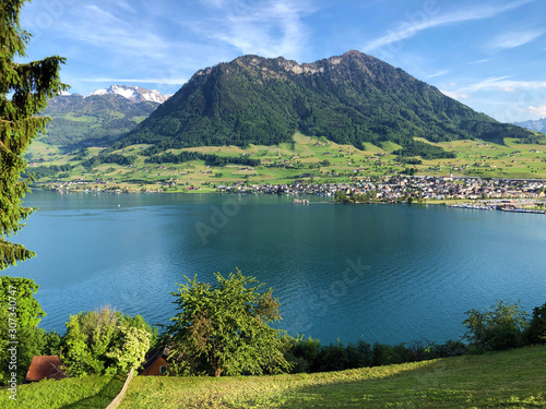 Settlement Buochs on the shores of Lake Luzerne or Vierwaldstaettersee (Vierwaldsattersee), at the end of the Engelbergertal Valley and Mountain Buochserhorn - Canton of Nidwalden, Switzerland photo