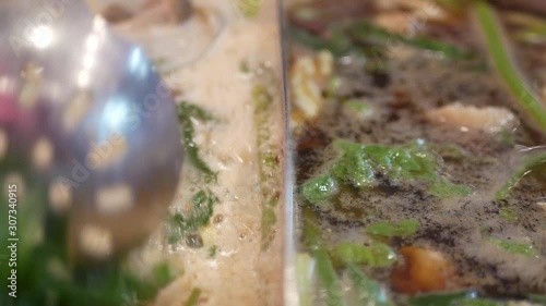 Selective focus and closeup of boiling hotpot (Shabu-shabu) with a bunch of vegetables and meat in the pot - a famous get-together meal in Thailand, among the locals, for a group of people or family