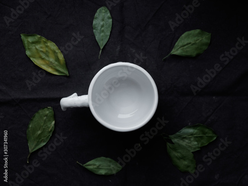leaf tea. Tea party concept. White cup and green leaves around