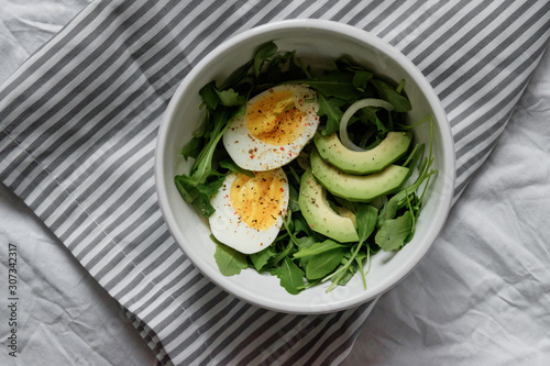 healthy green salad. Boiled eggs, herbs, onions and dressing. 