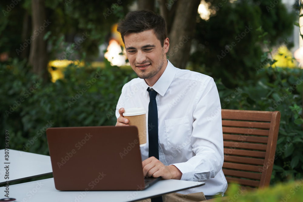businessman working on his laptop in park businessman working on his laptop in park
