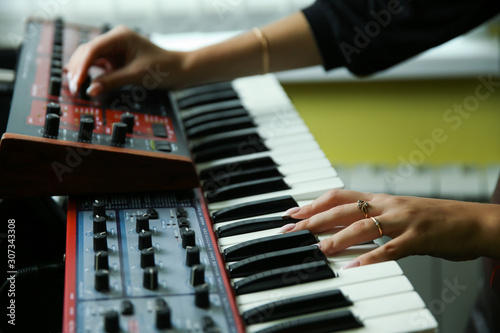 hands of a musician play a synthesizer photo