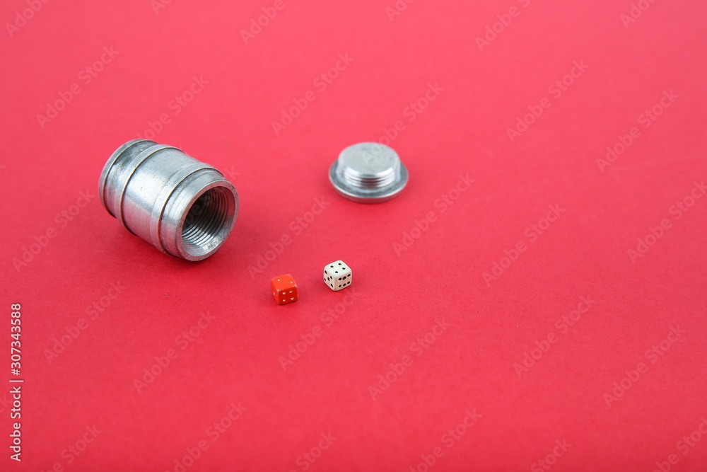 dice in a barrel on red background with copy space dice in a barrel on red background with copy space
