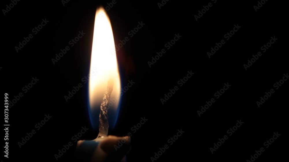 Close-up Single Candle Flame Isolated on Black Background Close-up Single Candle Flame Isolated on Black Background