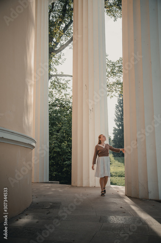 The girl next to the large columns