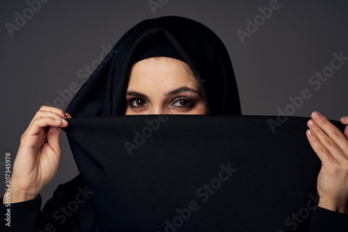 portrait of nun with hand on black background