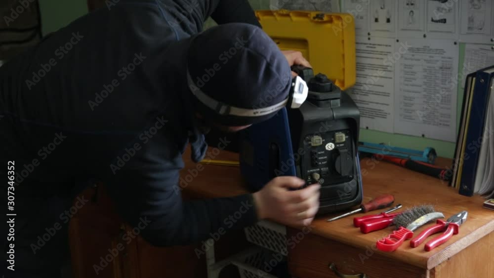 Man repair small diesel electrical appliance station. Man is fixing break in electronic device. Man from support is making service for fuel system of diesel engine. Man repair small diesel electrical appliance station. Man is fixing break in electronic device. Man from support is making service for fuel system of diesel engine.