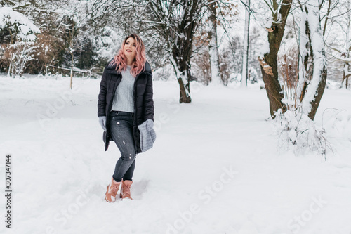 Young Blonde Woman in Gray Sweater and Black Jacket is Enjoying Winter © Romvy