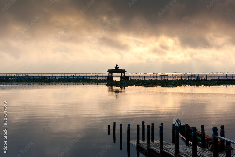 Fototapeta premium Local port in sunrise time for tourist services on a travelling to see the beautiful landscspe and lifestyle of people in the Inle Lake, Myanmar